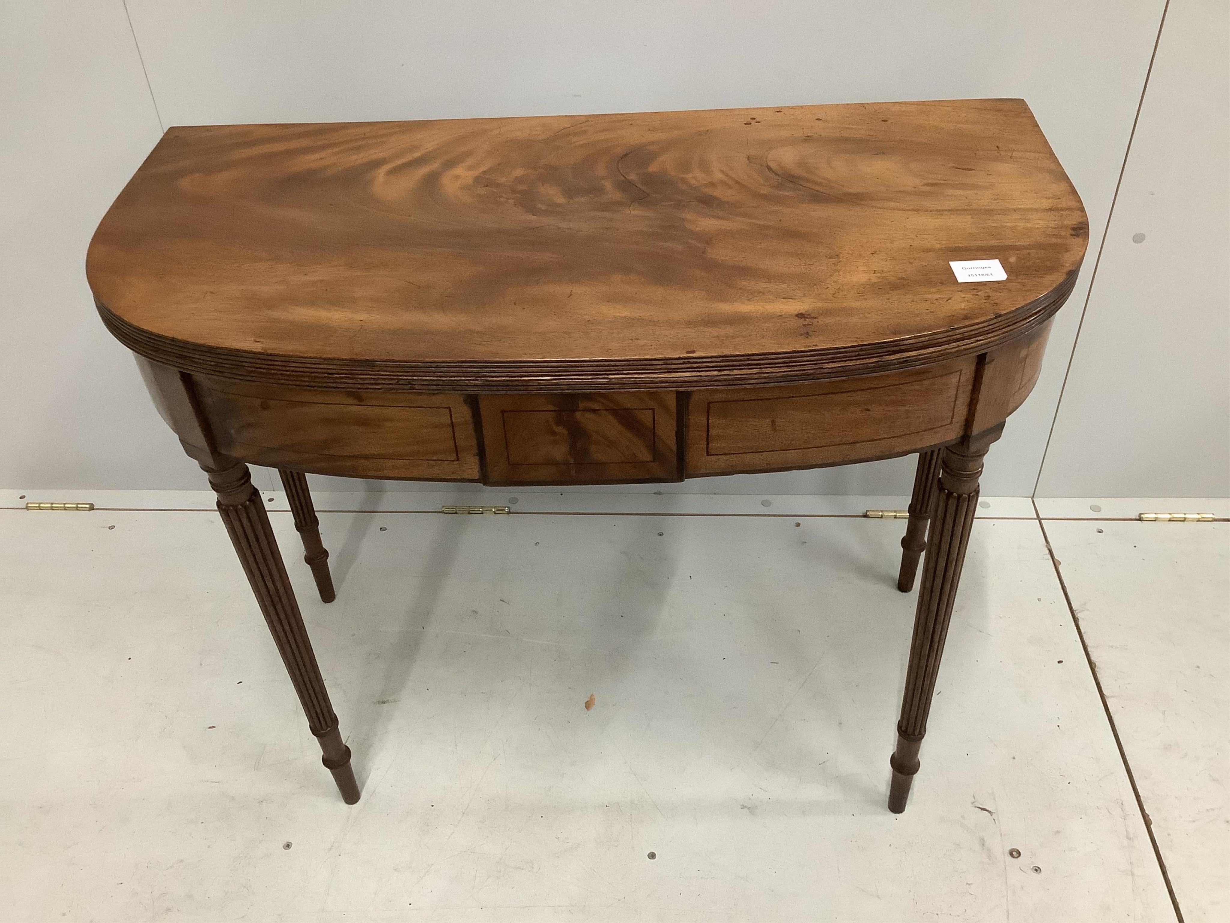 A George III mahogany D shaped folding tea table, width 91cm, depth 45cm, height 71cm. Condition - good